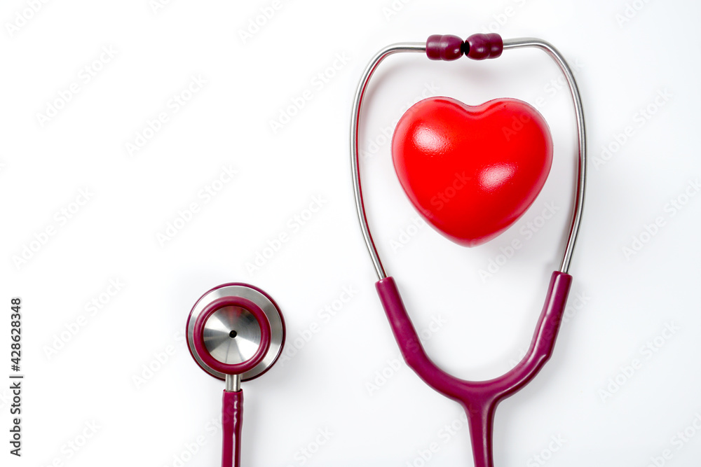 Top view of flat lay of medical stethoscope with red sharp heart on isolated white background. Healthy Living Concept. Top view of flat lay of medical stethoscope with red sharp heart on isolated white background. Healthy Living Concept.