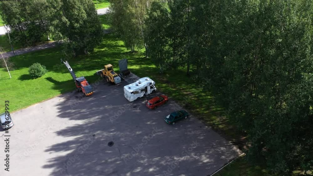 Aerial view of a RV, wild camping at a city park. parking lot - circling, drone shot