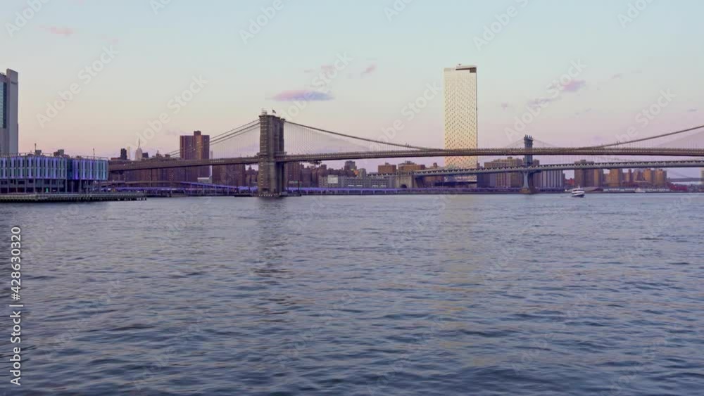 Brooklyn and Manhattan bridge seen from moving ferryboat, New York. Handheld shot Brooklyn and Manhattan bridge seen from moving ferryboat, New York. Handheld shot