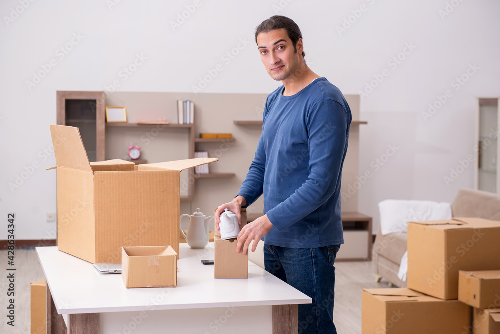 Young man moving to new flat Young man moving to new flat