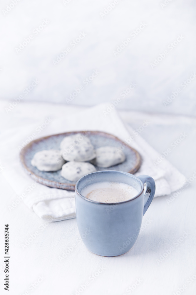Cappuccino and white chocolate cookies on bright wooden background. Copy space. Cappuccino and white chocolate cookies on bright wooden background. Copy space.