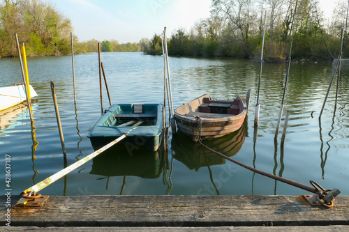 Fototapeta Naklejka Na Ścianę i Meble -  Abandoned rowing boat, isolated on a lake. Two  rowboat on water.