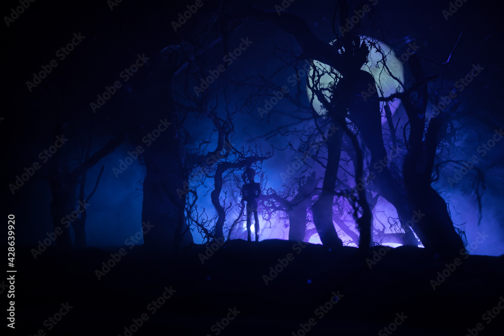 Fototapeta premium bloodthirsty zombies attacking. hungry zombies in the woods. Silhouettes of scary zombies walking in the forest at night