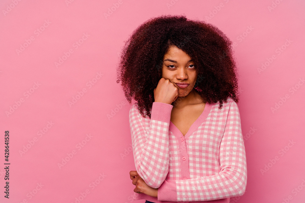 Young african american woman isolated on pink background who feels sad and pensive, looking at copy space. Young african american woman isolated on pink background who feels sad and pensive, looking at copy space.
