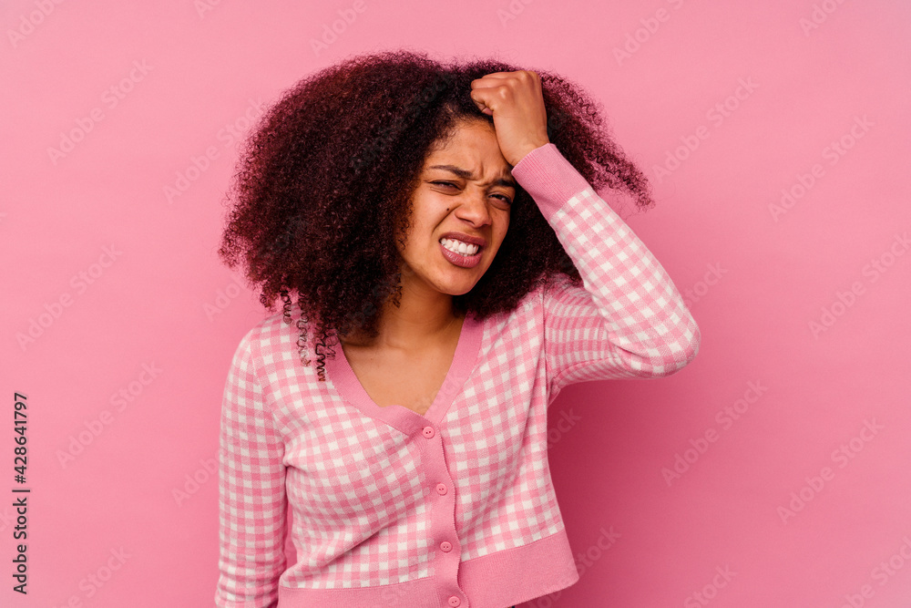 Young african american woman isolated on pink background forgetting something, slapping forehead with palm and closing eyes. Young african american woman isolated on pink background forgetting something, slapping forehead with palm and closing eyes.