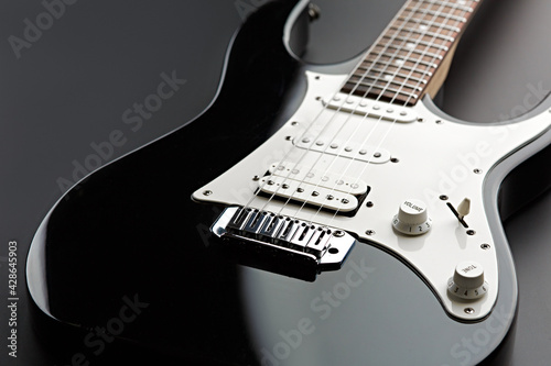 Modern electric guitar, black background, nobody