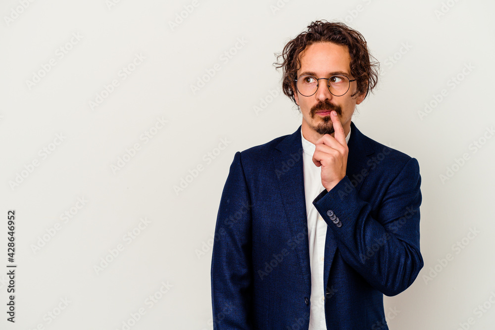 Young business man isolated on white background looking sideways with doubtful and skeptical expression. Young business man isolated on white background looking sideways with doubtful and skeptical expression.