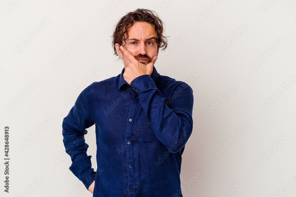 Young caucasian man isolated on white background contemplating, planning a strategy, thinking about the way of a business. Young caucasian man isolated on white background contemplating, planning a strategy, thinking about the way of a business.