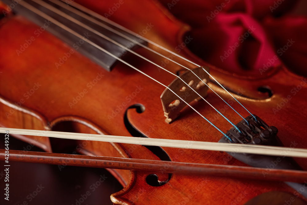 Violin in retro style and bow, closeup view Violin in retro style and bow, closeup view