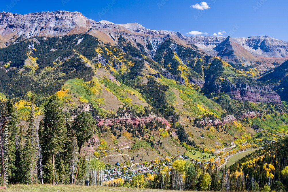 Fototapeta premium Telluride Below - Autumn aerial view of Mt. Sneffels Wilderness with the Town of Telluride below, in the San Juan mountains of southwestern Colorado, San Miguel County