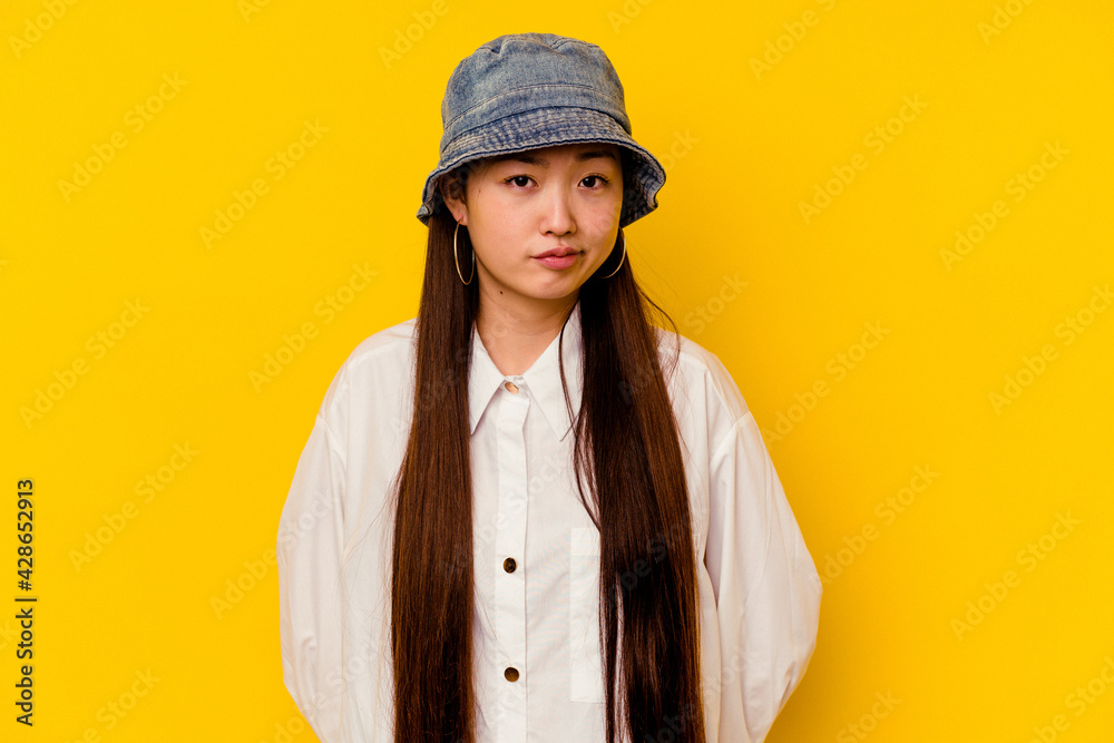 Young chinese woman isolated on yellow background sad, serious face, feeling miserable and displeased. Young chinese woman isolated on yellow background sad, serious face, feeling miserable and displeased.