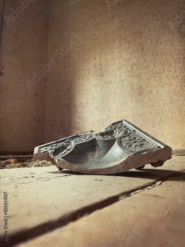 closeup view on broken tile on a floor in an abandoned house