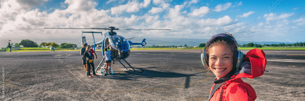 Helicopter ride Asian tourist passenger woman boarding flight on cruise excursion activity in Hawaii. Panoramic banner of summer travel vacation lifestyle. Helicopter ride Asian tourist passenger woman boarding flight on cruise excursion activity in Hawaii. Panoramic banner of summer travel vacation lifestyle.