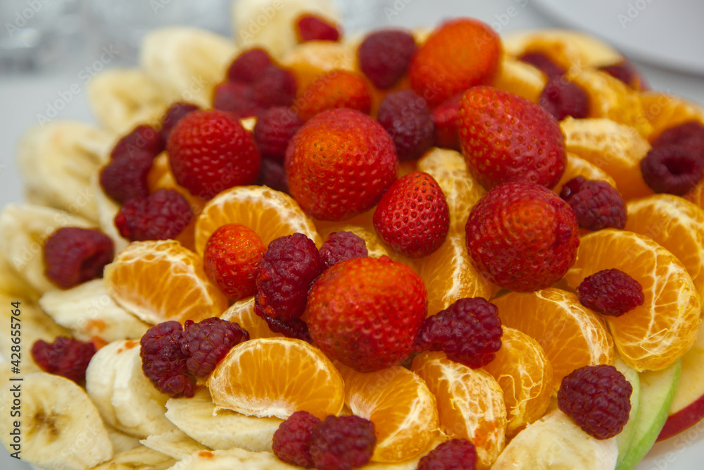 Fruit plate consisting of banana, Apple, Mandarin, strawberry and raspberry. Fruit plate consisting of banana, Apple, Mandarin, strawberry and raspberry.