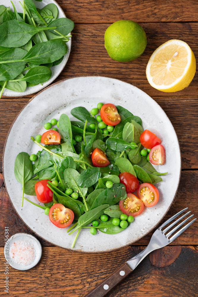 Healthy detox salad with baby spinach and cherry tomatoes. Weight loss, dieting concept. Table top view Healthy detox salad with baby spinach and cherry tomatoes. Weight loss, dieting concept. Table top view