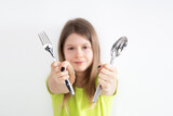 Girl with spoon and fork isolated on the white background