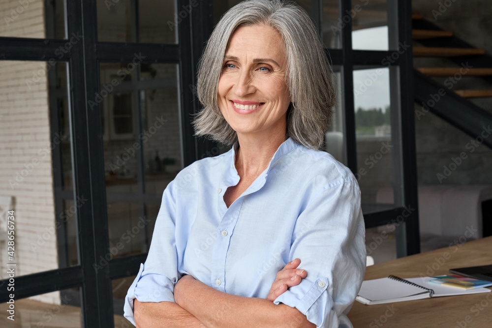 Good Looking Mid Aged Woman Portrait At Home. Elegant Business Woman.  Middle-Aged Woman Standing In Modern Home. Stock Photo, Picture and Royalty  Free Image. Image 129107489.