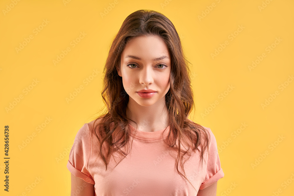 Obraz premium Beautiful girl in casual clothes isolated on yellow background.