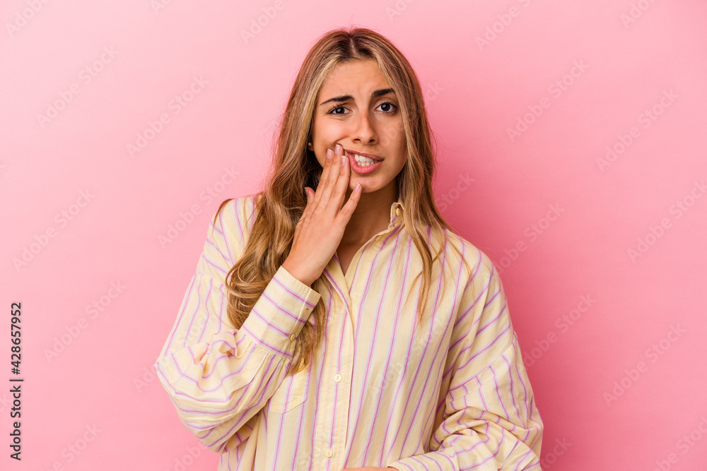 Young blonde caucasian woman isolated on pink background having a strong teeth pain, molar ache. Young blonde caucasian woman isolated on pink background having a strong teeth pain, molar ache.