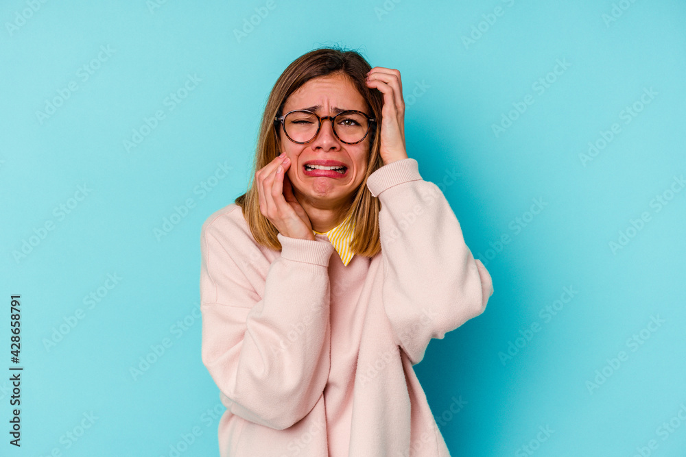 Young student caucasian woman isolated on blue background whining and crying disconsolately. Young student caucasian woman isolated on blue background whining and crying disconsolately.