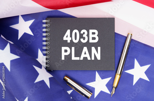 On the table is an American flag, a pen and a notebook with the inscription - 403B PLAN