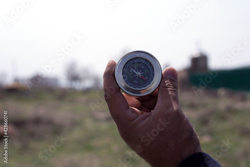 compass in man hand nature background