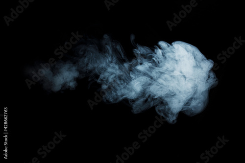 Abstract white smoke moves on black background. Beautiful swirling gray smoke.