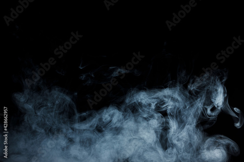 Abstract white smoke moves on black background. Beautiful swirling gray smoke.