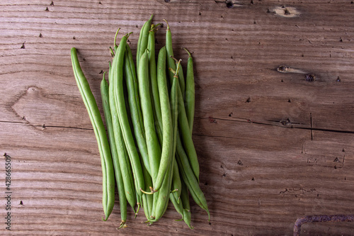 fresh green beans on a wooden table