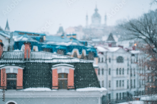 Copious snowfall over the city with the roofs