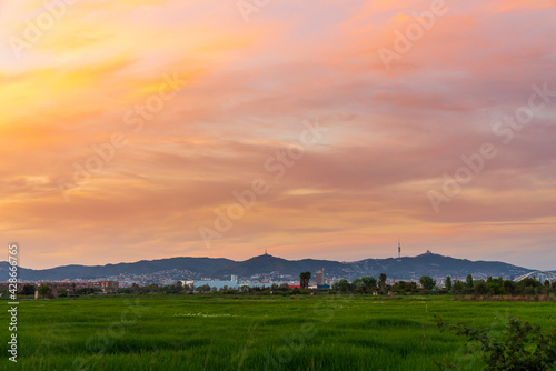 Sunset on the mountain of Collserola in Barcelona. From the Llobregat delta. We can see the silhouette of the communications antenna and the Tibidabo amusement park.