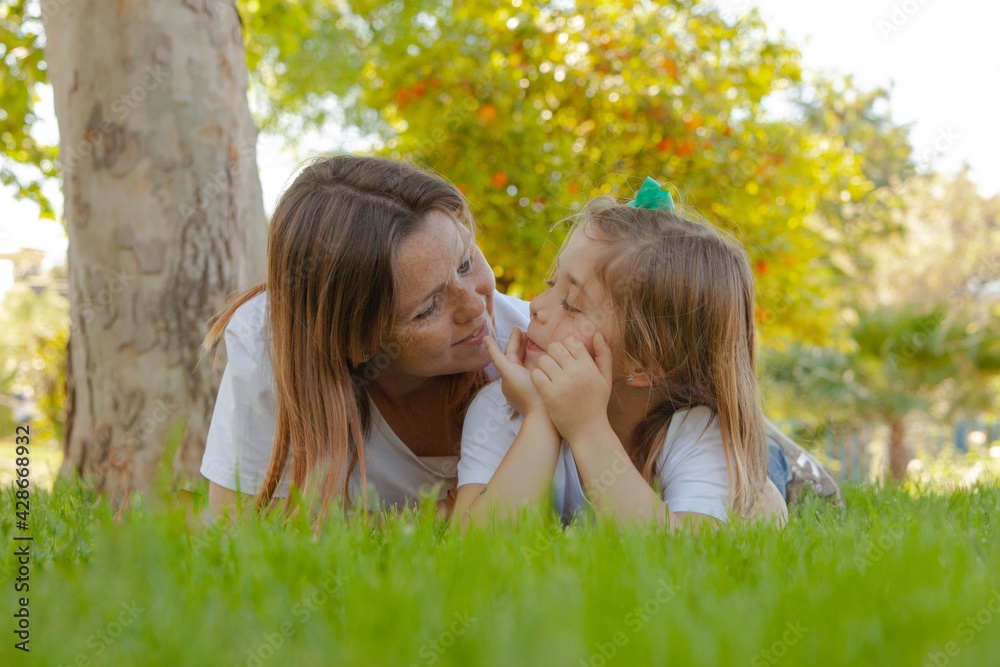 mother and daughter talking outdoors mother and daughter talking outdoors