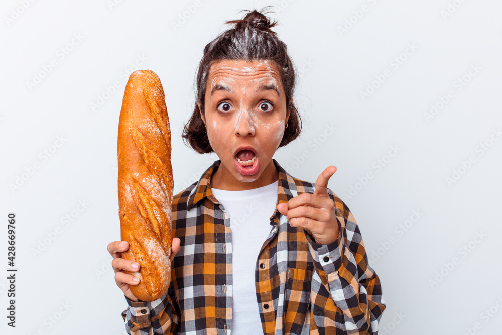 Young mixed race woman making bread isolated on white background having an idea, inspiration concept. Young mixed race woman making bread isolated on white background having an idea, inspiration concept.