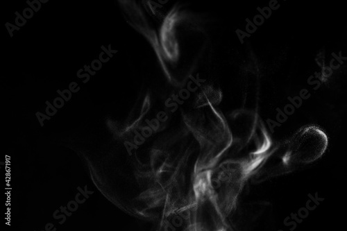Real photo of white steam smoke on isolate solid black background with abstract blur motion wave swirl use as an overlay effect for vapor cigarette dry ice hot food soup tea coffee 