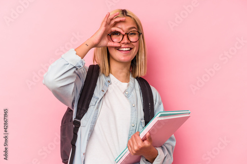 Young venezuelan student woman isolated on pink background excited keeping ok gesture on eye.