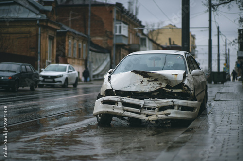 Auto accident on the street. A car damaged after a severe accident stands on a city street. Accident insurance concept. © Vladislav
