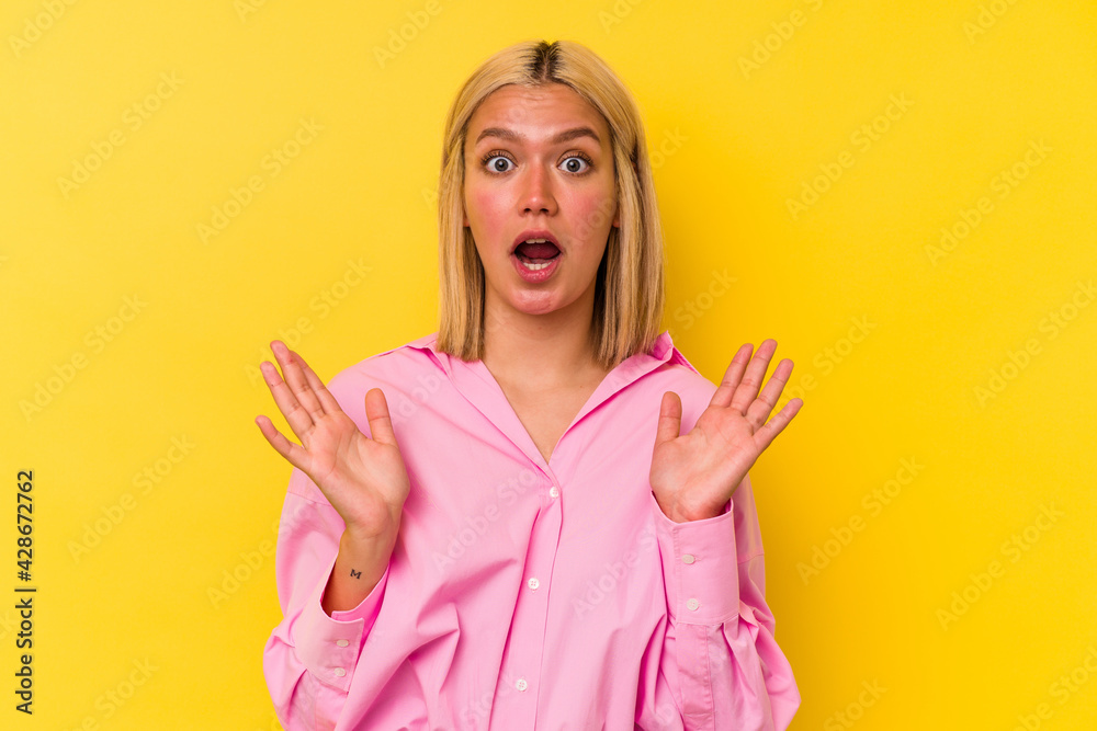 Young venezuelan woman isolated on yellow background surprised and shocked. Young venezuelan woman isolated on yellow background surprised and shocked.