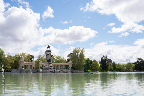 Lake at Retiro park, Madrid, on a sunny day. Some boats and people in the distance