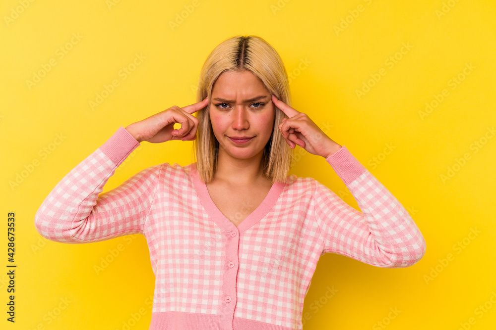 Young venezuelan woman isolated on yellow background focused on a task, keeping forefingers pointing head. Young venezuelan woman isolated on yellow background focused on a task, keeping forefingers pointing head.