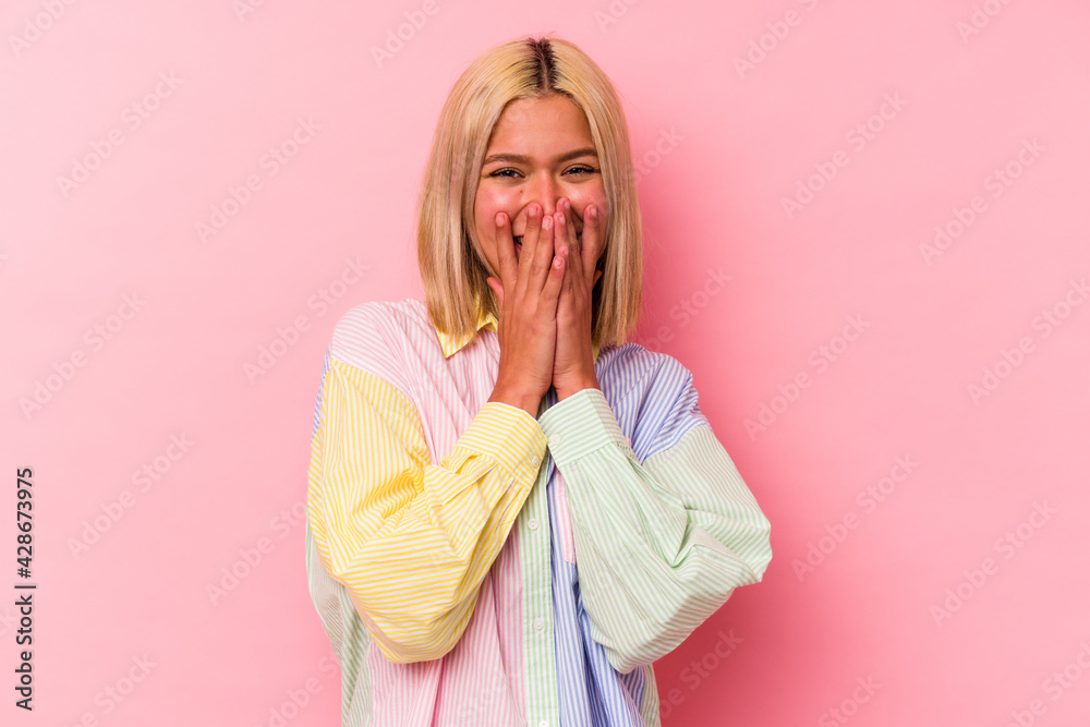 Young venezuelan woman isolated on pink background laughing about something, covering mouth with hands. Young venezuelan woman isolated on pink background laughing about something, covering mouth with hands.