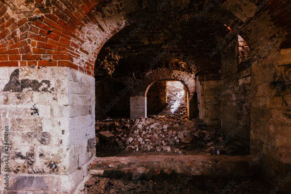 Old vaulted red brick cellar under abandoned building