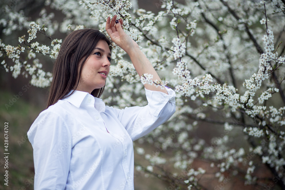 Portrait of beautiful young woman at spring in orchard Portrait of beautiful young woman at spring in orchard