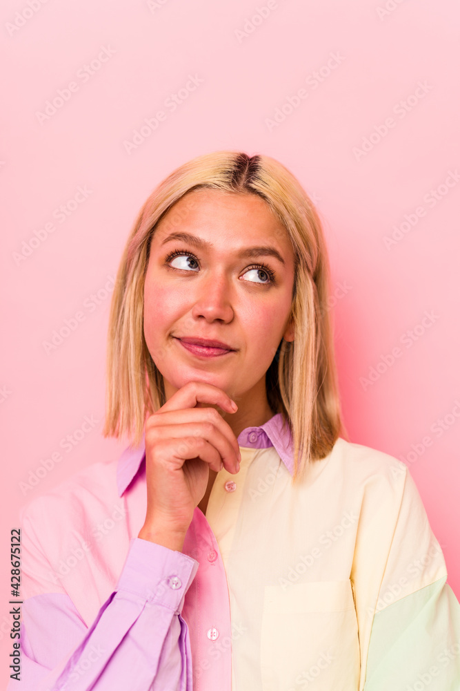 Young caucasian woman face closeup isolated on pink background Young caucasian woman face closeup isolated on pink background