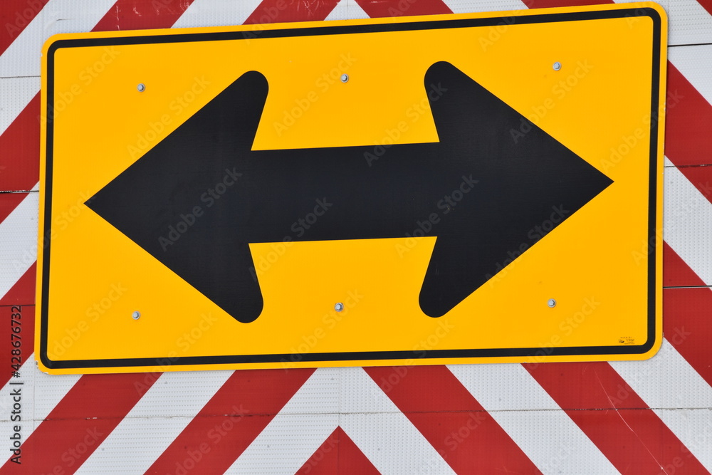 Fotografie Black Arrow on a Road Sign