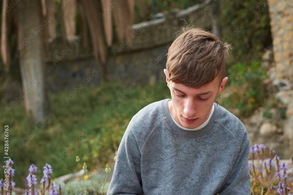 A shallow focus shot of a young Caucasian guy with a serious facial expression and green eyes A shallow focus shot of a young Caucasian guy with a serious facial expression and green eyes