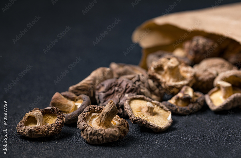 Closeup dried shiitake mushrooms in a brown paper bag