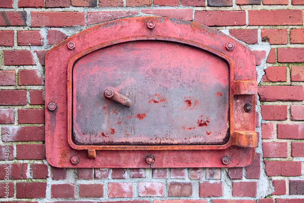 Red Incinerator Door with Red Brick Background Red Incinerator Door with Red Brick Background