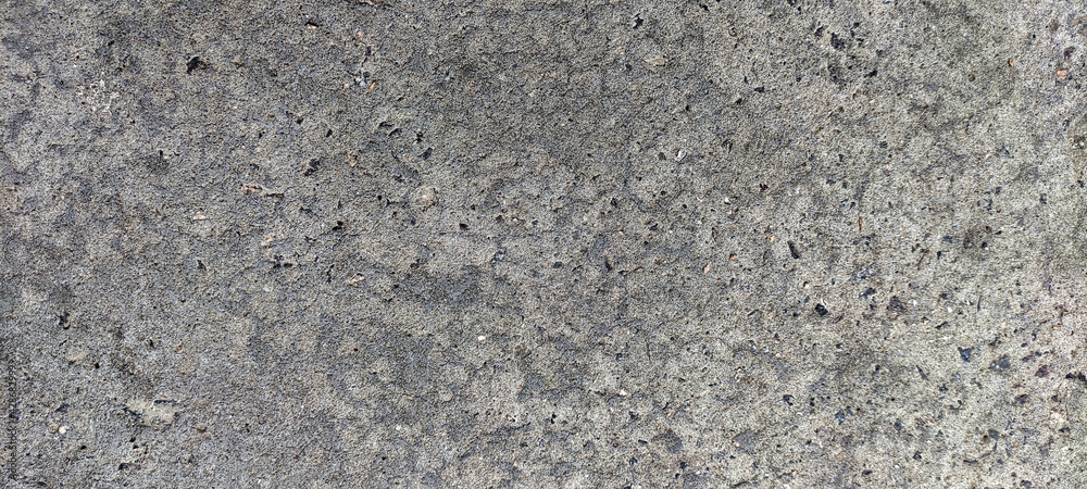 A view of the texture of the gray concrete. Gray background A view of the texture of the gray concrete. Gray background
