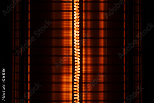 Close up of an electric heater coil with grill protection