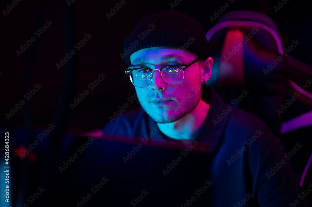 Close-up of the face of a professional video game player at an esports tournament. A cyberathlete wearing headphones and a headset. Close-up of the face of a professional video game player at an esports tournament. A cyberathlete wearing headphones and a headset.